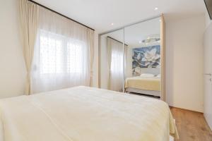 a bedroom with a bed and a large mirror at HoUsE MILETIC in Solin +44 photos