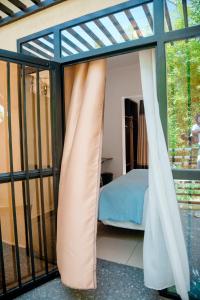 a room with a bed and a window at Migano Hotel in Ruhengeri