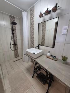 a bathroom with a sink and a mirror at Gerendás in Szilvásvárad