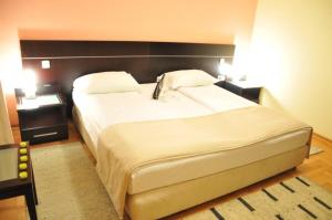 a large white bed in a bedroom with a headboard at hotel yu in SJJ