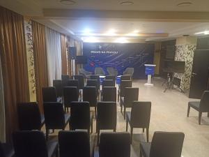 a room with chairs and a stage and a screen at hotel yu in SJJ
