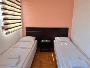 a small room with two beds and a window at hotel yu in SJJ