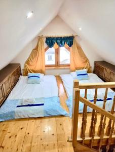 a bedroom with two beds in a attic at ApartPodhale in Raba Wyżna +116 photos
