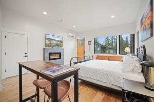 a bedroom with a bed and a table and a fireplace at 18136-2 Forestbrook Loop in Bend +17 photos