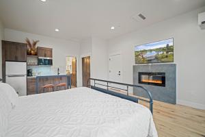 a white bedroom with a bed and a fireplace at 18136-2 Forestbrook Loop in Bend