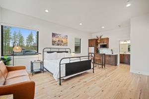 a bedroom with a bed and a living room at 18136-2 Forestbrook Loop in Bend