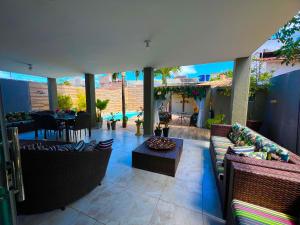 an outdoor patio with chairs and a table and a table at Casa Brisa do Mar in Cabedelo