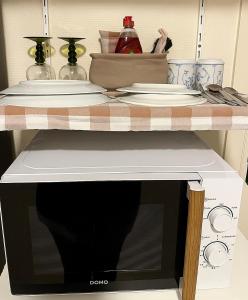 a microwave oven with plates on top of it at SomeTimes in Roeselare