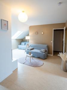 a bedroom with a bed and a table at Cosy app near sea in Cabourg