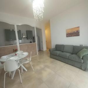 a living room with a couch and a table and chairs at Casa Manzoni 45 in Scandicci