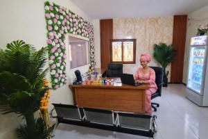 a woman sitting at a desk with a laptop at Résidence Senghor - THIÈS in Thiès