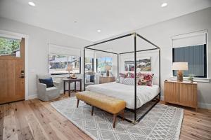 a bedroom with a canopy bed and a chair at 18145-2 Forestbrook Loop in Bend