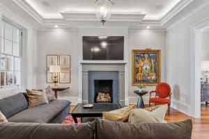 a living room with a couch and a fireplace at Historic CBD Townhomes with Courtyard in New Orleans