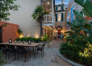 a patio with a table and chairs and plants at Historic CBD Townhomes with Courtyard in New Orleans