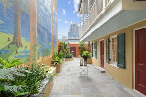 a corridor of a building with plants and a mural at Historic CBD Townhomes with Courtyard in New Orleans +45 photos
