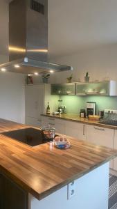 a kitchen with a wooden counter top in a kitchen at Bright Rooms with WiFi , Terrace between Freiburg and France , private Zimmer in Freiburg im Breisgau