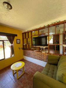a living room with a couch and a table at Brisa Campestre in Tomatlán