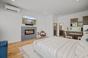 a white bedroom with a bed and a fireplace at 18157-2 Forestbrook Loop in Bend