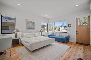 a living room with a bed and a couch and windows at 18157-2 Forestbrook Loop in Bend