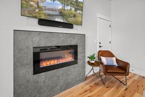 a living room with a fireplace and a chair at 18157-2 Forestbrook Loop in Bend