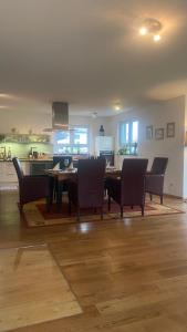 a dining room with a table and chairs and a kitchen at Bright Rooms with WiFi , Terrace between Freiburg and France , private Zimmer in Freiburg im Breisgau +37 photos
