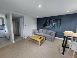 a living room with a couch and a table at Greenmount - 1 Bed Apartment in Naas