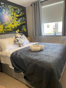 a bedroom with a bed with two towels on it at Greenmount - 1 Bed Apartment in Naas