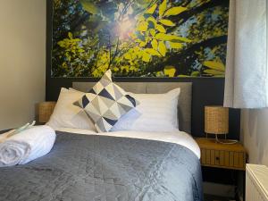 a bedroom with a bed with a painting on the wall at Greenmount - 1 Bed Apartment in Naas