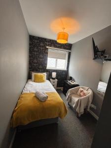 a bedroom with two beds and a chair in it at Ugie House in Keith