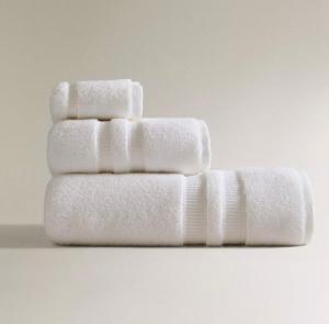 four white towels stacked on top of each other at Lora Luxury Suite 6 ,free private parking, self check in, air conditioner in Como +40 photos