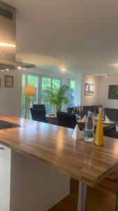 a kitchen and dining room with a large wooden table at Bright Rooms with WiFi , Terrace between Freiburg and France , private Zimmer in Freiburg im Breisgau