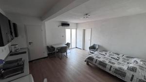 a bedroom with a bed and a desk with chairs at Barth Apartments in Donji Štoj