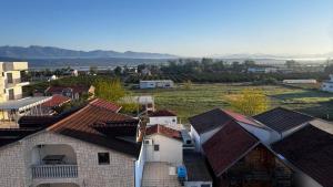a view of roofs of houses and a field at Barth Apartments in Donji Štoj
