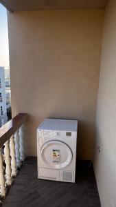 a washing machine sitting in the corner of a room at Barth Apartments in Donji Štoj