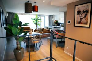 a living room with a glass table with a plant at Prime apartment in Liège