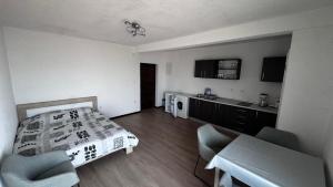 a bedroom with a bed and a table and chairs at Barth Apartments in Donji Štoj