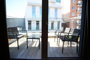 a view of a balcony with chairs and a table at Prime apartment in Liège