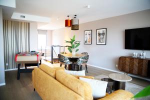 a living room with a couch and a table at Prime apartment in Liège