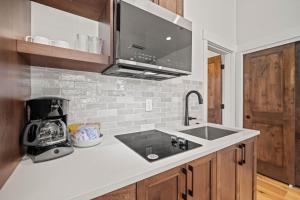 a kitchen with a sink and a microwave at 18163-2 Forestbrook Loop in Bend +20 photos