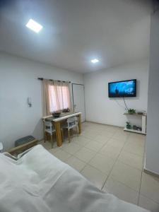 a bedroom with a bed and a table and a tv at La Buena Memoria in San Juan