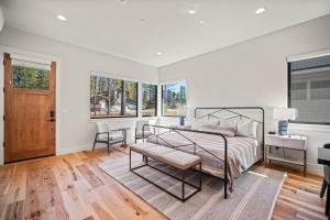 a bedroom with a bed and a desk and windows at 18163-2 Forestbrook Loop in Bend