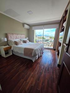 a bedroom with a large bed and a large window at Caseros Desings Salta in Salta +105 photos