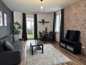 a living room with a couch and a tv and a table at 2BR, terrace, free parking in Leverkusen