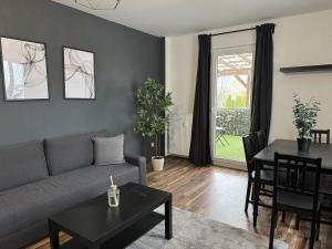 a living room with a couch and a table at 2BR, terrace, free parking in Leverkusen