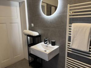 a bathroom with a white sink and a mirror at 2BR, terrace, free parking in Leverkusen +27 photos