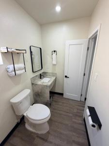 a bathroom with a white toilet and a sink at Scenic Motel - El Monte in El Monte