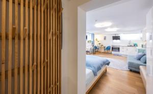 a bedroom with a bed and a living room at Ruhig Top mod Studio Appartement,privater Eingang in Oberhaching