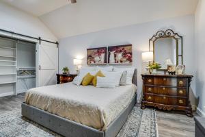 a bedroom with a large bed and a mirror at Backyard Bungalow w/ Pool & Country Views in Argyle +22 photos