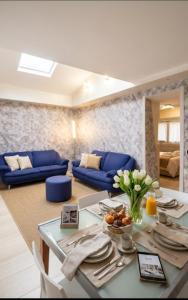 a living room with blue couches and a table at Meson Cavour in Avigliano