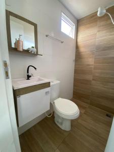 a bathroom with a toilet and a sink and a shower at Pousada Por do Sol in Lapa +45 photos